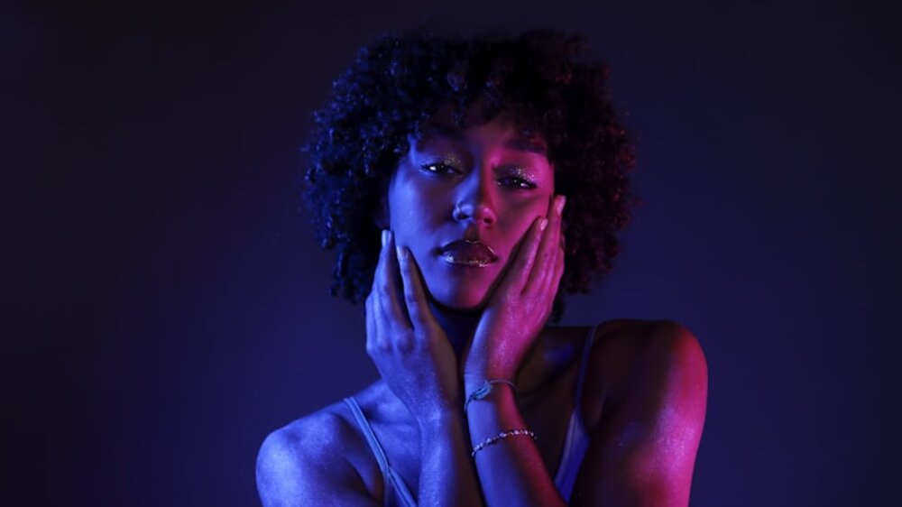 Glowing skin under red light — full-body photobiomodulation